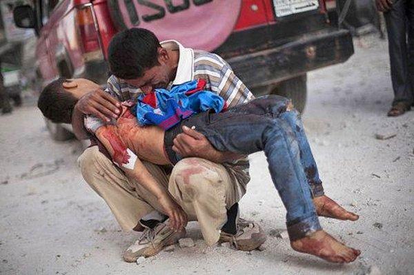 18. Halep'te intihar bombacılarının kurbanı olan oğlunun cansız bedenine kapanmış ağlayan baba