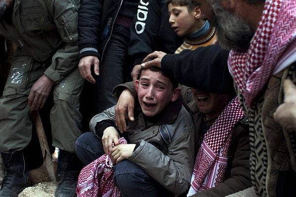 2012'de Pulitzer ödülü kazanan portfolyodan bir fotoğraf. Rodrigo Abd tarafından çekilmiş ve babası Suriyeli bir keskin nişancı tarafından vurulan çocuğun, cenazedeki halini yansıtıyor.