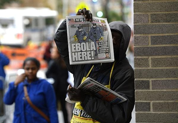 34. Batı Afrika'dan New York'a yeni dönen Sınır Tanımayan Doktorlar üyesi Craig Spencer'ın Ebola virüsü taşıdığı haberinin manşet yapıldığı New York Post gazetesinin satışını yapan gazete satıcısı. 24 Ekim