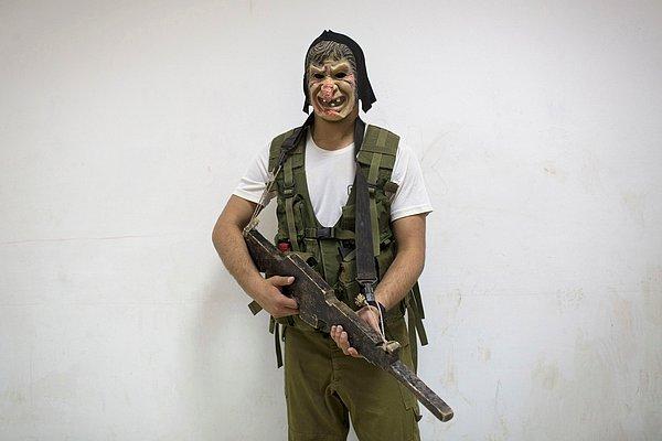 19. İsrailli bir lise öğrencisi, kentsel mücadele tatbikatı sırasında, özel olarak işletilen askeri eğitim, savaş ve spor eğitiminin bir parçası olarak maskeyle poz veriyor.