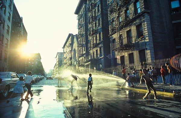 64. New York, Harlem'de bir yangın musluğu etrafındaki gençler (1977)