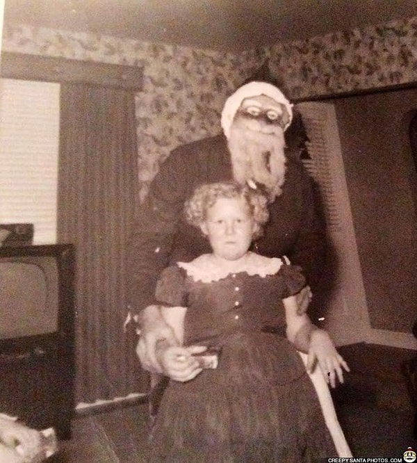 15. Этот Санта-Клаус даже держит девчушку за руки, чтобы она не смылась из кадра.