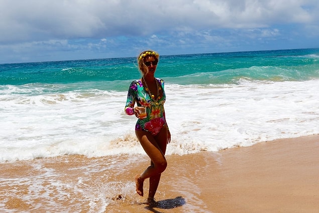 13. She looks perfect in her flower-patterned and long-sleeved swim suit and radiates on the Hawaii beaches!