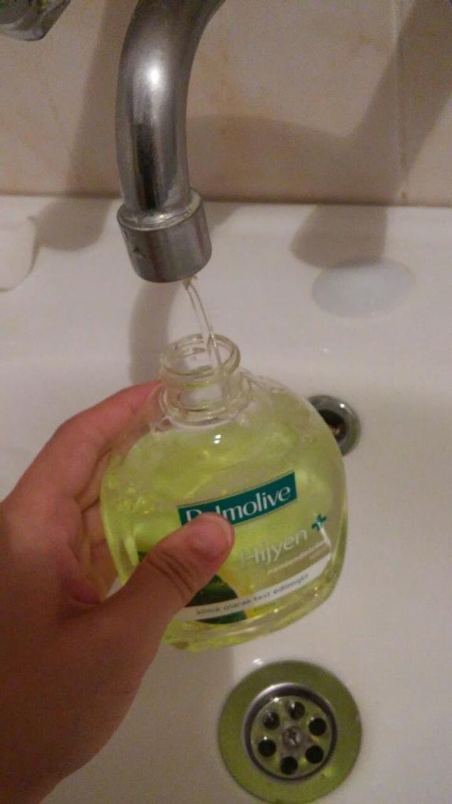 12. Filling the shampoo bottle with water.