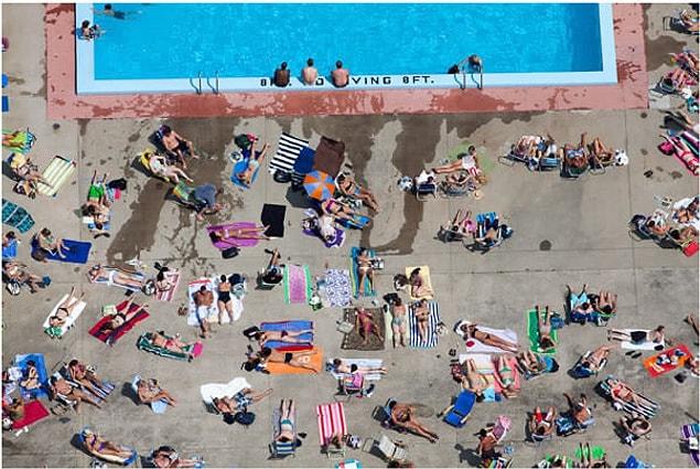 8. People tanning on a poolside near Massachusetts
