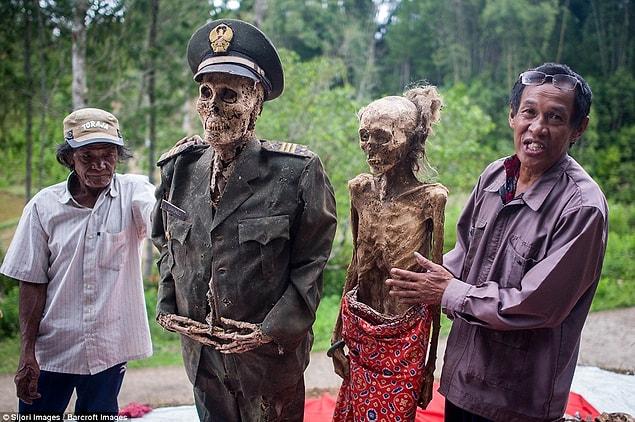 The tribe from Sulawesi island exhume their dead, who they wash and dress in fresh clothes and then pose for family photographs in a festival known as Ma'nene.