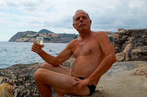 2. Old European guy with a very small bathing suit.