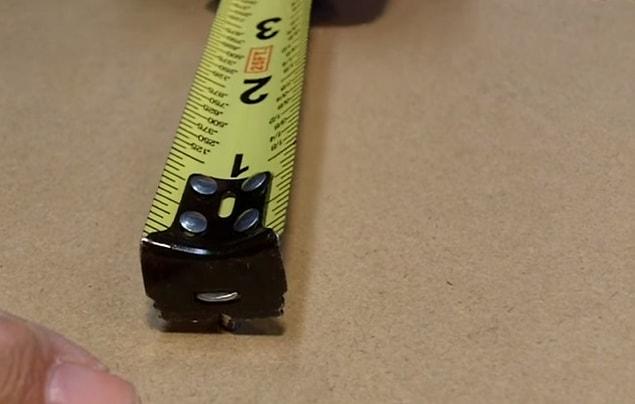 The hole is designed to attach it to a nail to measure the distance.