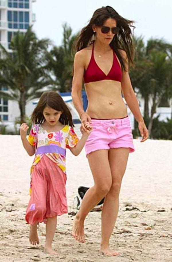 Actress Katie Holmes, pictured here with daughter Suri, also has an outside belly button. She is often spotted in her bikini and looks fantastic.