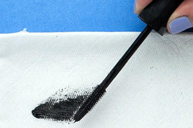 9. Remove excess mascara from the wand.