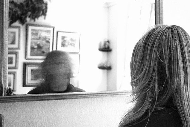 8. Performing weird gestures in front of the mirror such as making different facial gestures or swaying back and forth.