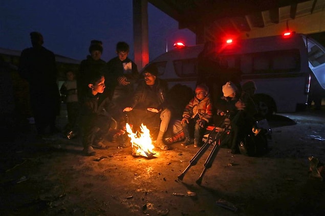 12. Displaced Syrians sit around a fire on Nov. 30 in Jibreen, east of Aleppo.