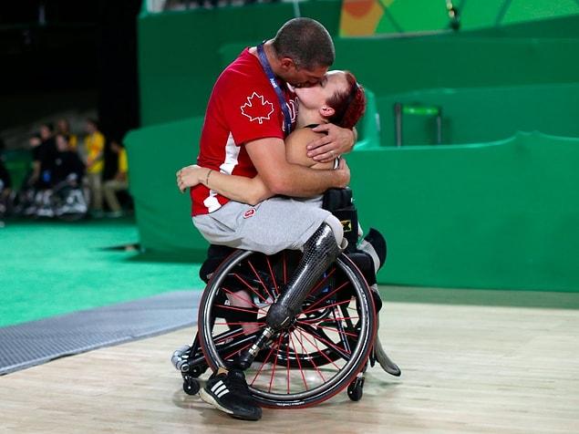 8. Canada's men's wheelchair basketball team player Adam Lancia kisses his wife Jamey Jewells of Canada after her match at the Rio Paralympics.