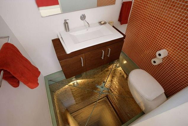 8. This bathroom with a glass floor for those who would enjoy to live on the edge!