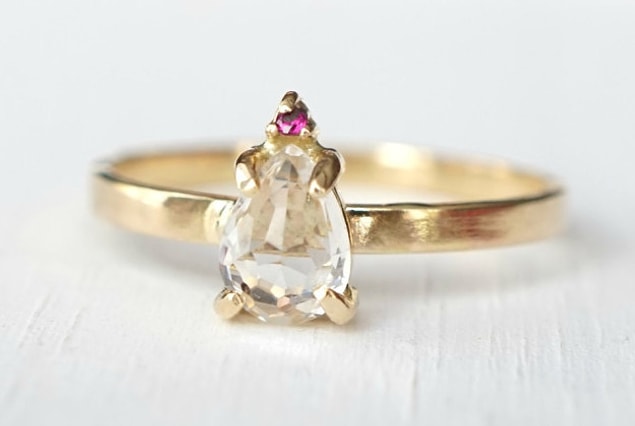 16. A white topaz and ruby ring inspired by your happy tears!