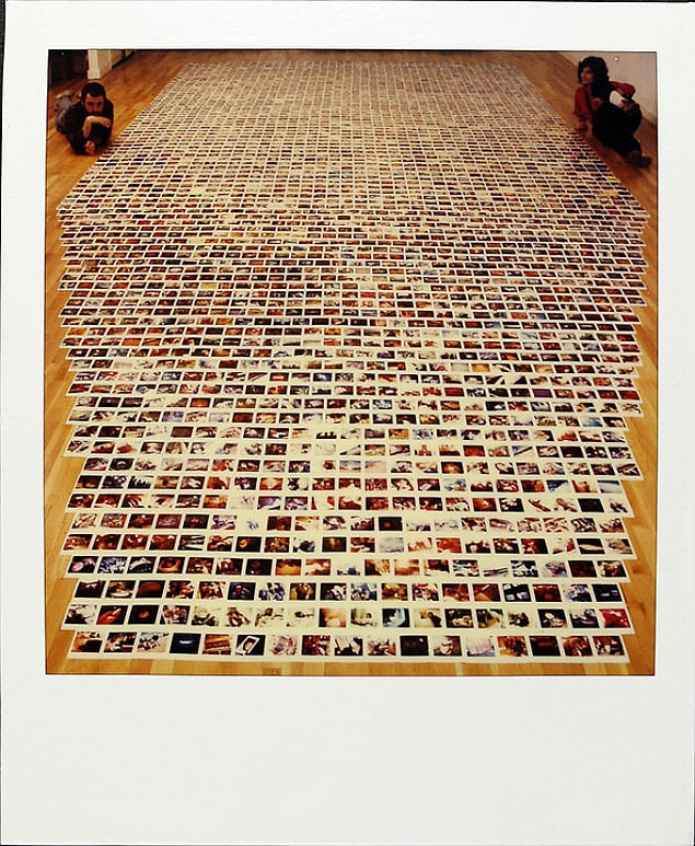 March 30, 1988: He lays all out his photographs. By now he has thousands of them.