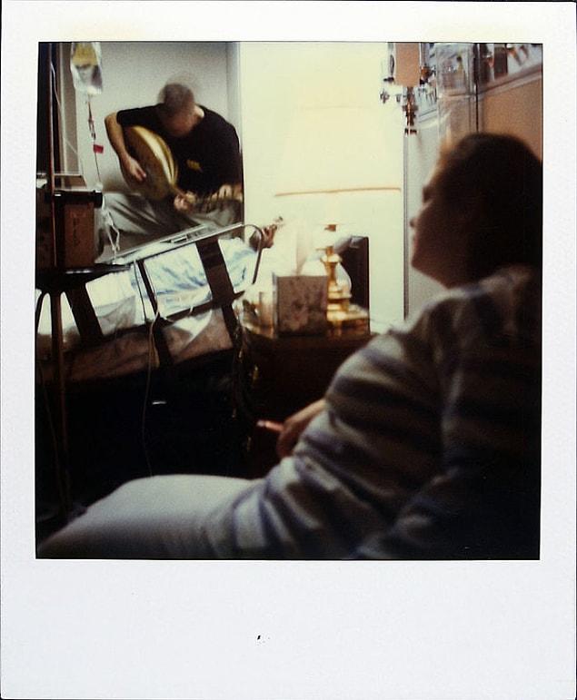 October 24, 1997: A friend plays music for him in the hospital.