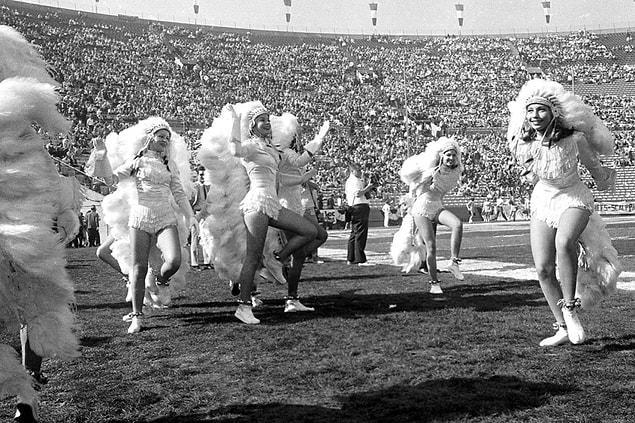11. Cheerleaders in glamorized faux Native American costumes attempt to excite the crowd.