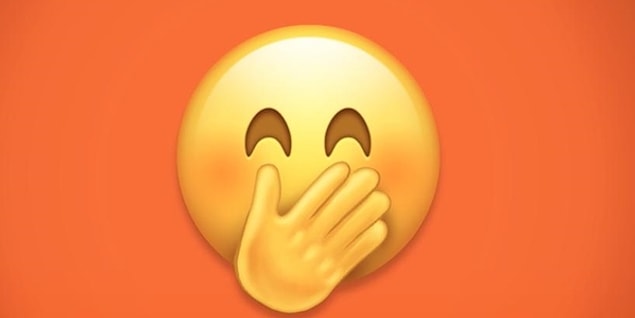 Smiling face with smiling eyes and hand covering mouth.