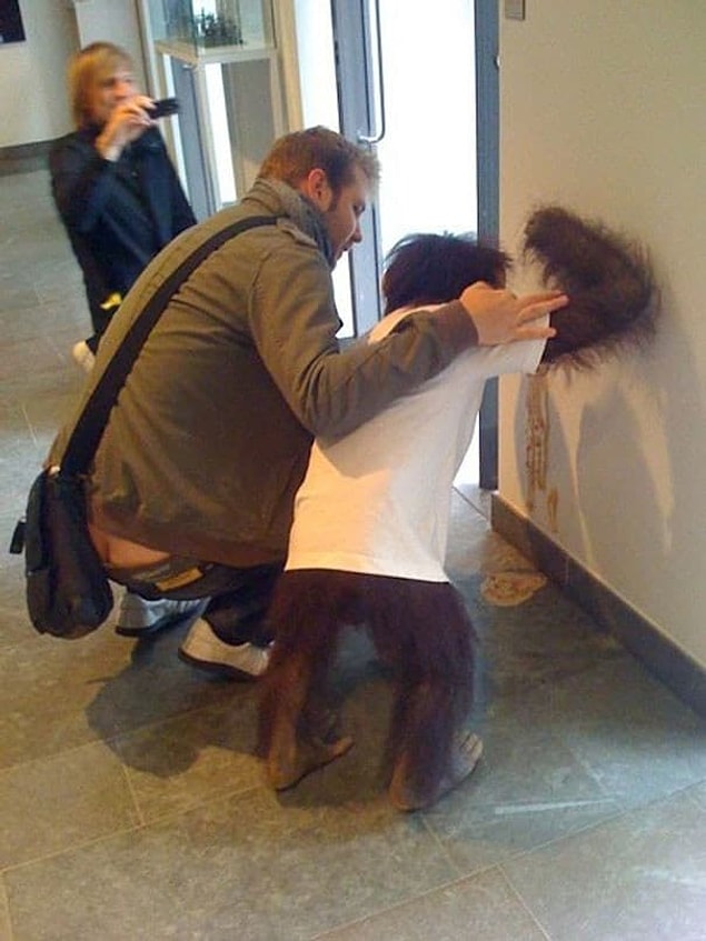 18. While this guy — in arguably the most random picture on the internet — got stuck holding back his monkey friend's hair.