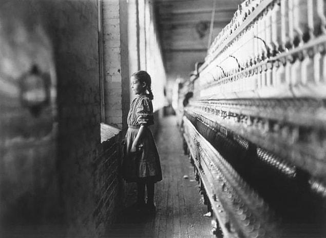 20. A young girl looks out of a factory window during her shift at a cotton mill in Lincolnton, North Carolina, circa 1908.