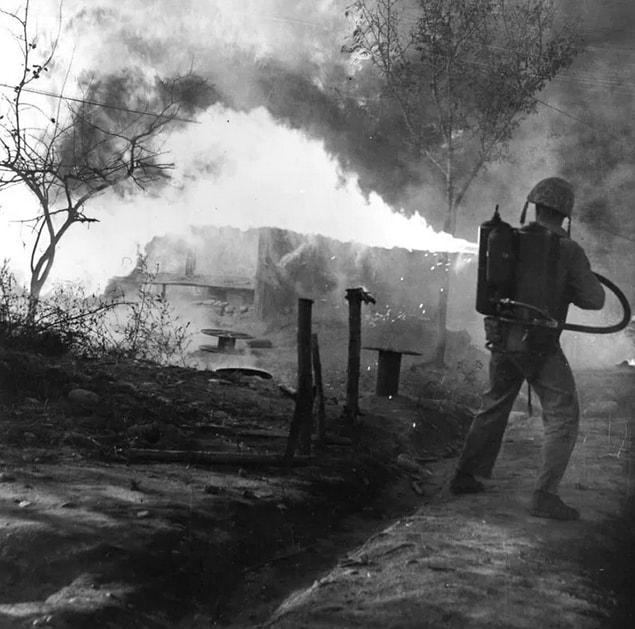 3. An American soldier uses a flamethrower to burn out North Korean soldiers in March 1951.