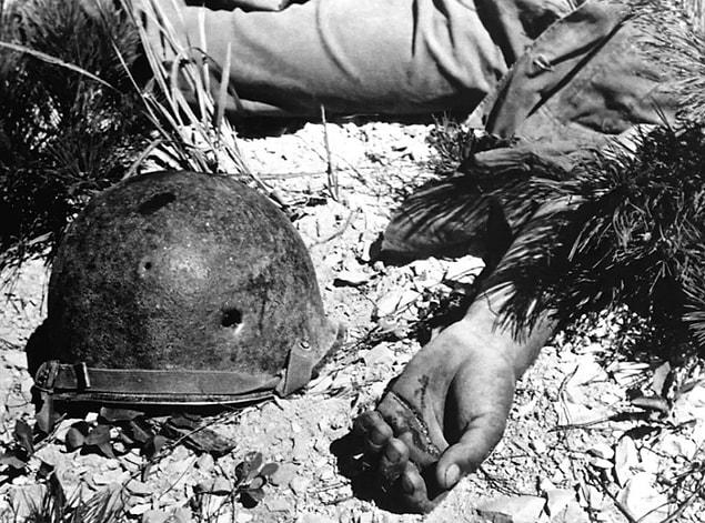 18. A helmet riddled with bullet holes left beside the body of a soldier killed on the way to Maeson Dong on Sept. 2, 1950.