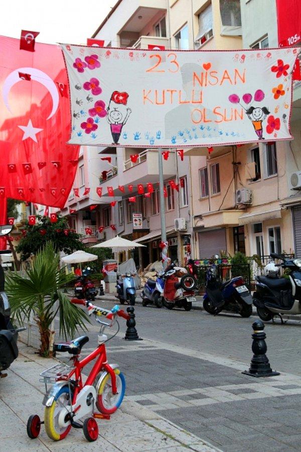 Çocukların kendi elleriyle çizip boyadıkları ve üzerinde "23 Nisan Kutlu Olsun" yazılı bez afiş de sokaktaki yerini aldı.