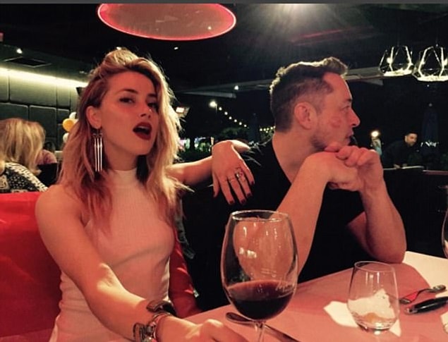 It seemed to be an intimate affair as they sat at a dinner table alongside each other while Amber placed her hand on the shoulder of the 45-year-old Tesla inventor and entrepreneur.