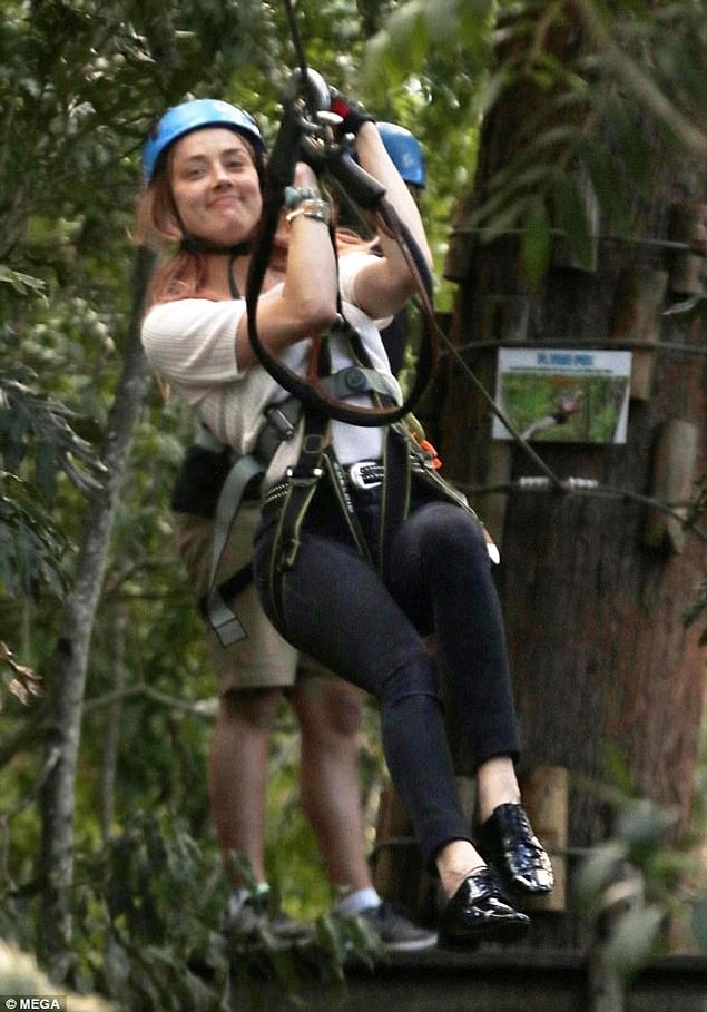 Amber Heard looks happy with her new boyfriend, Elon Musk.