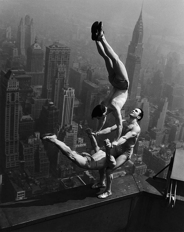 13. Acrobats trying to balance on the roof of the Empire State Building. | 1934