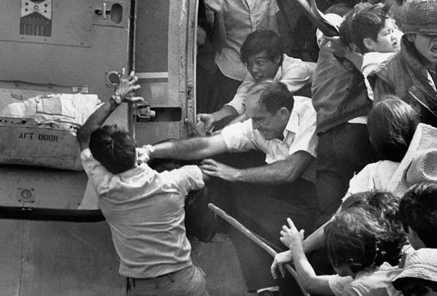 53. An American punching a Vietnamese to protect his place in the last helicopter taking off from the US Embassy during Saigon evacuation. | 1975