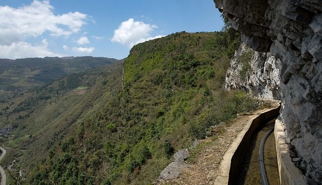 While the mythical Yu Gong was helped by divine intervention, Huang Dafa, village chief of Caowangba, in the mountains of Guizhou, could only rely on his will and the power of persuasion to build a long water channel through three karst mountains.