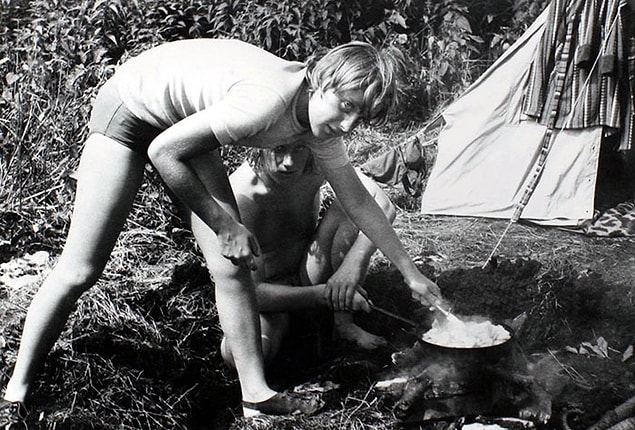 18. Angela Merkel Prepares A Meal On A Campfire While Camping With Friends In Himmelpfort, German Democratic Republic In July 1973