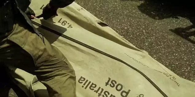 4. Kaptan Bumerang ile ilk tanıştığımızda, Avustralyalı kötü karakter, Avustralya damgalı bir torbada geliyor.