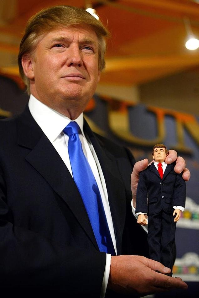 12. Trump showing off a tiny Trump at a press event in 2004.