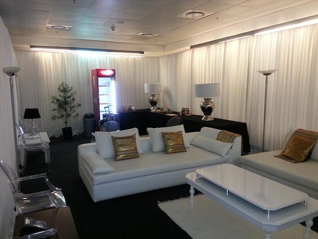 17. A large glass-door refrigerator, clothing shelves, eight power outlets, and 12 white handkerchiefs in the room.