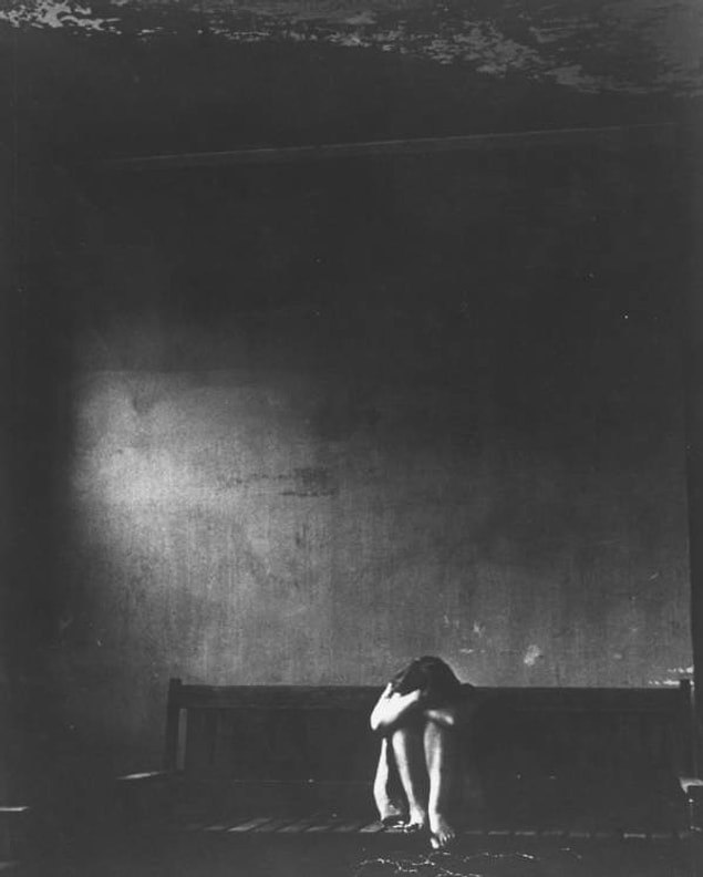 18. A patient sits alone in a dark room inside Ohio's Cleveland State Mental Hospital on February 3, 1955.