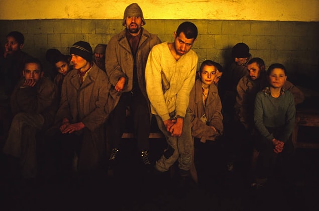 19. Patients at the Riul Vadului Mental Asylum in Romania huddle together in an unheated room in the middle of winter. Date unspecified.