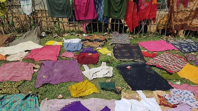Arakanlı Müslümanların çoğu yoğun yağmur altında sınırı geçmeye çalıştı. Islanan kıyafetlerini böyle kurutuyorlar.