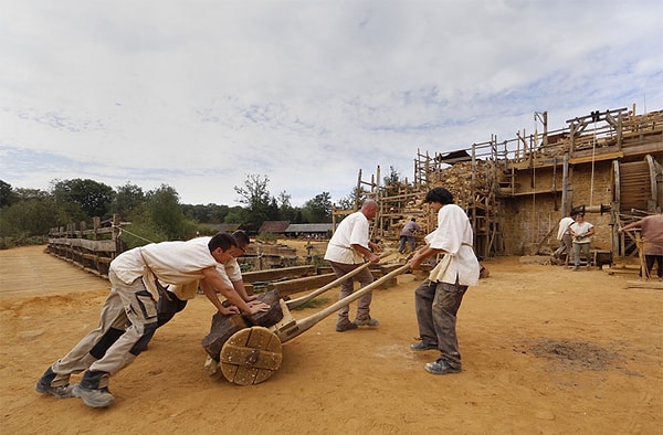 4. Работники используют тележку для транспортировки камней