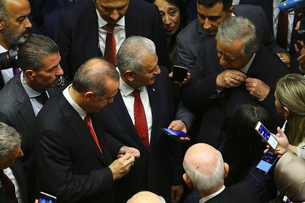 Erdoğan, MHP Genel Başkan Yardımcısı Celal Adan'la rozetlerini değiştirdi. Adan “Bayrak değişimi” diyerek espri yaptı.