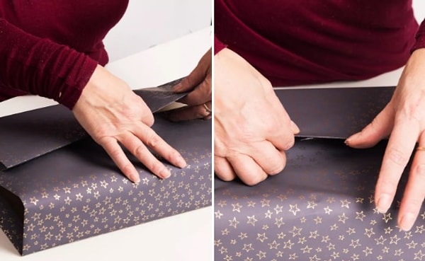 2. Приклеиваем двусторонний скотч к одному из вертикальных краев. Начинаем оборачивать подарок. Шов должен быть внизу коробки. Снимаем со скотча защитную пленку и аккуратно приклеиваем край.