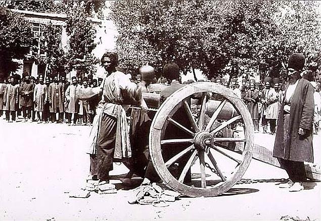 6. Persian man waiting for execution in front of an artillery, at the end of 19th century