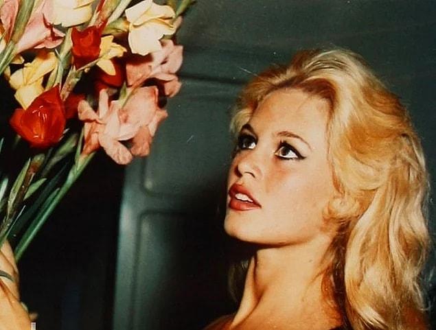 5. Brigitte Bardot with a bouquet of flowers.