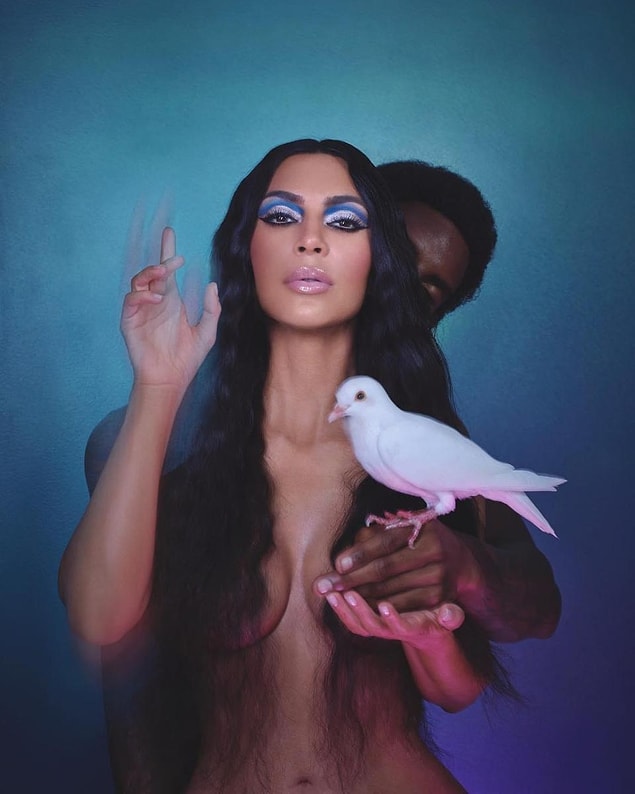 She poses with a man as they prop up a dove in the shots.