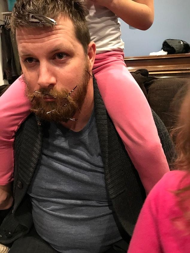 Daddy’s beard is the perfect place for her to perfect her hairstyling skills.