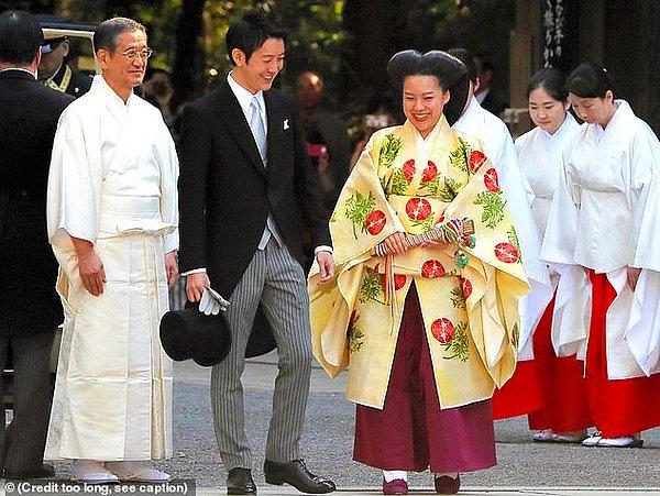 Takamado Prensesi Ayako ve Kei Moriya düğünleri öncesi Meiji Jingu Mabedi'nde salona yürüyorlar.