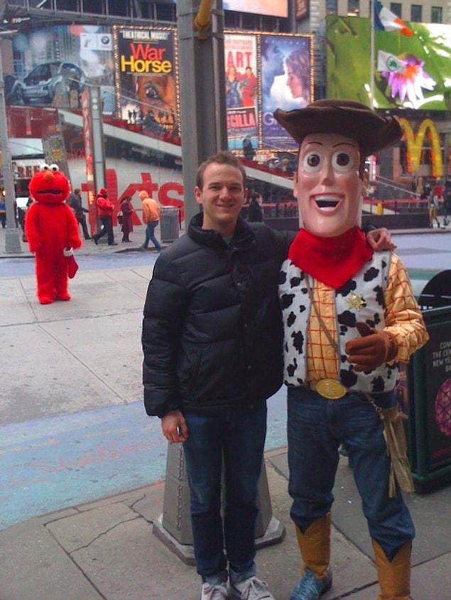 8. Elmo looks so sad that this guy is taking a picture with Woody and not with him