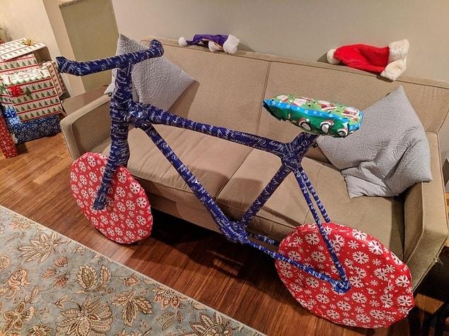 2. “Bought my brother tree trimmers for Christmas, built a cardboard frame around them and wrapped them like this.”